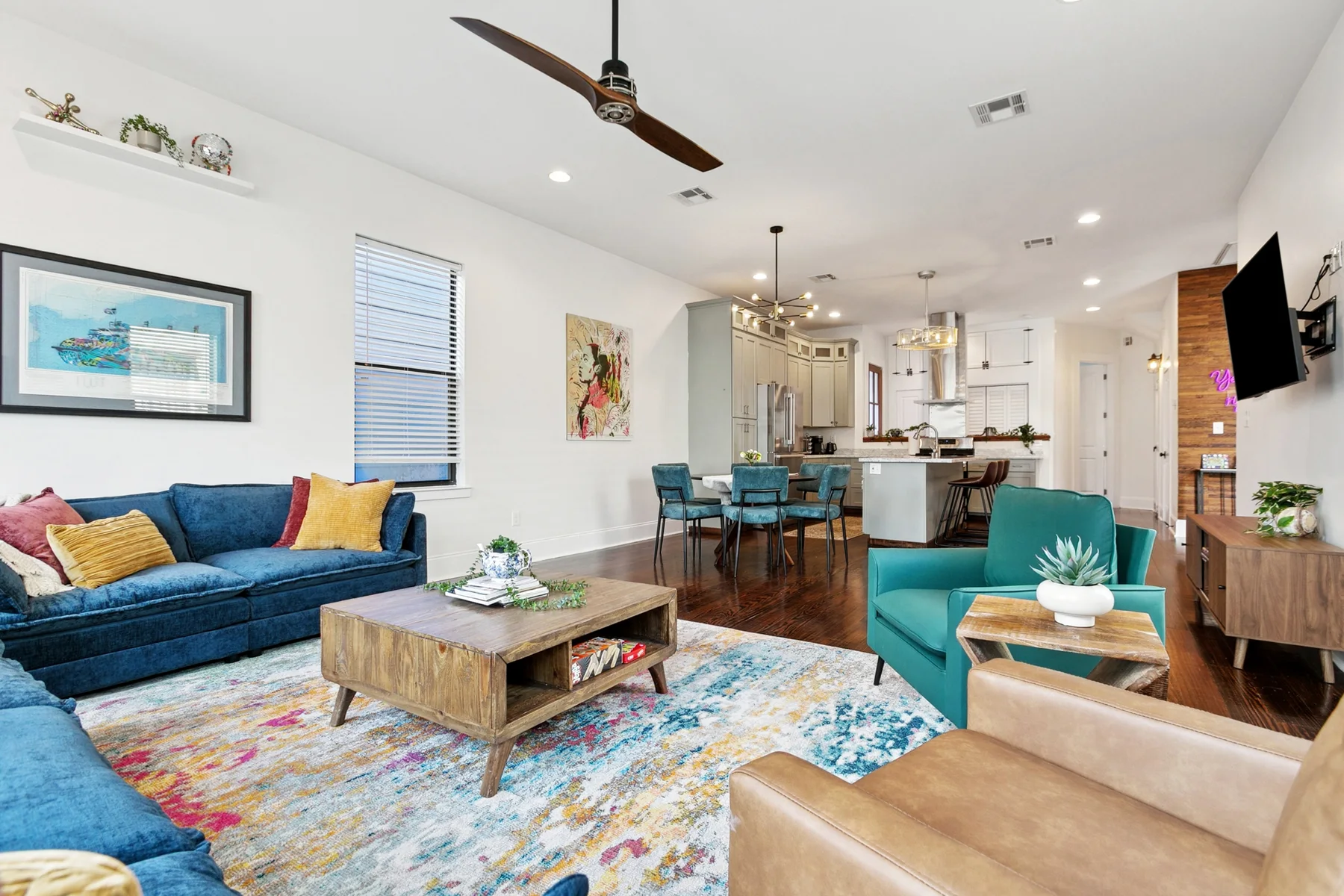 The bright living room with teal sofas at our Bywater vacation home